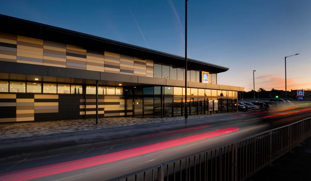 Aldi supermarket featuring modern external wall cladding in contrasting panel finishes.